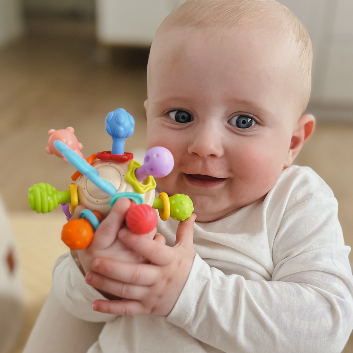 Woopie Baby Mäkká hrkálka 2v1 hryzátka Senzorická hračka pre bábätká 0m+