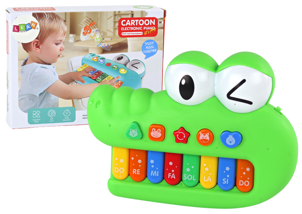 O crocodilo verde do órgão musical educacional do piano soa da luz