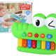 O crocodilo verde do órgão musical educacional do piano soa da luz